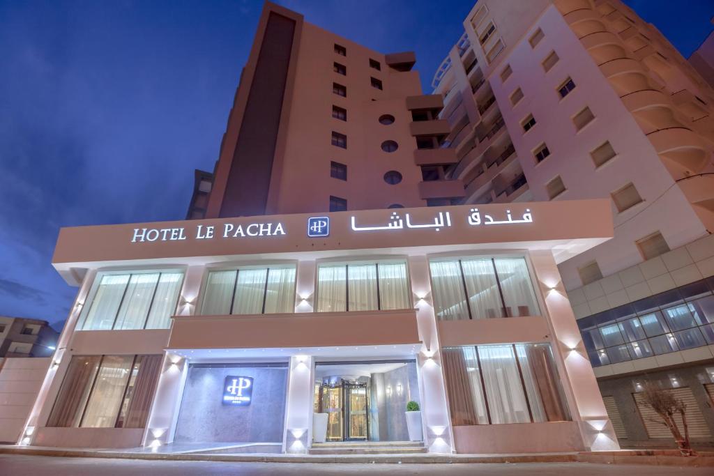 a hotel in front of two tall buildings at Hotel Pacha in Oran