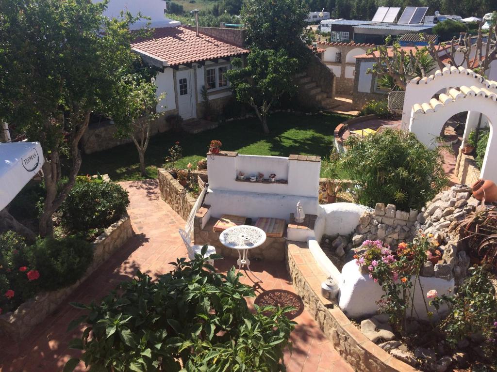 an aerial view of a garden with a bench at Casinhas da Figueira in Budens