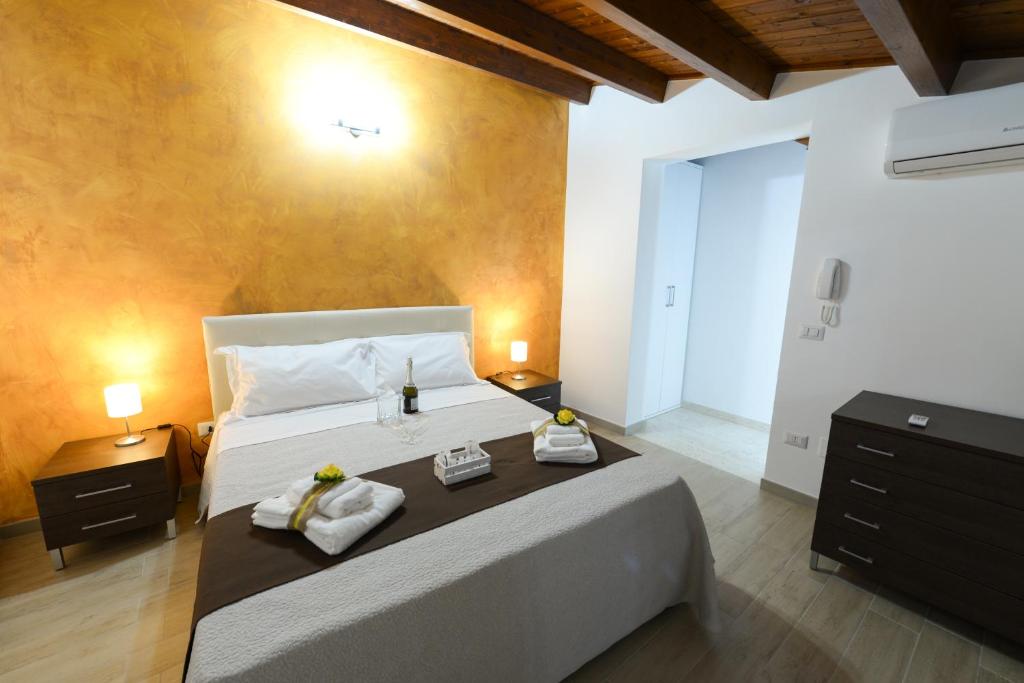 a bedroom with a large bed with towels on it at Dimora Civitas Severiana in Montescaglioso