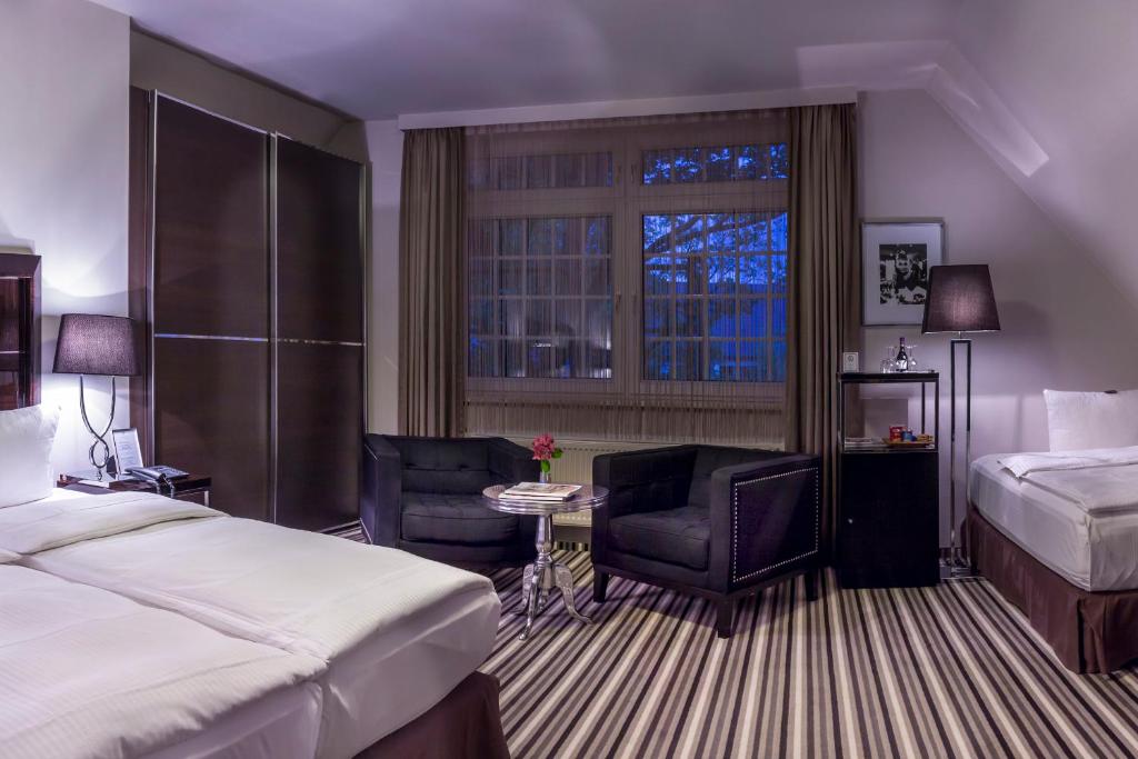 Postel nebo postele na pokoji v ubytování Boutique Hotel Poppenbütteler Hof