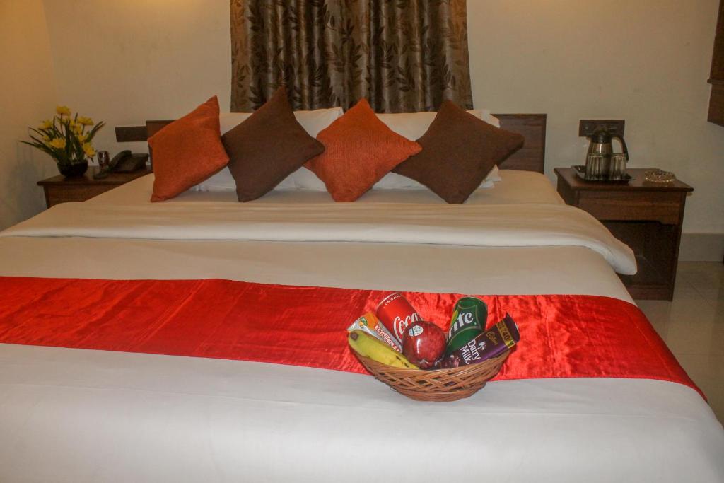 a bedroom with a bed with a basket of medicines at Wise Owl Comfotel in Kolkata