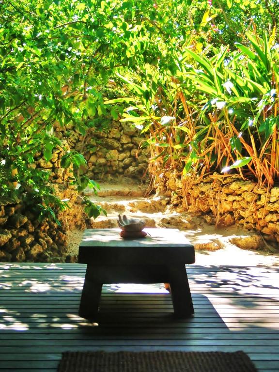 a bench sitting in the middle of a patio at Taketomijima Akaneya in Taketomi