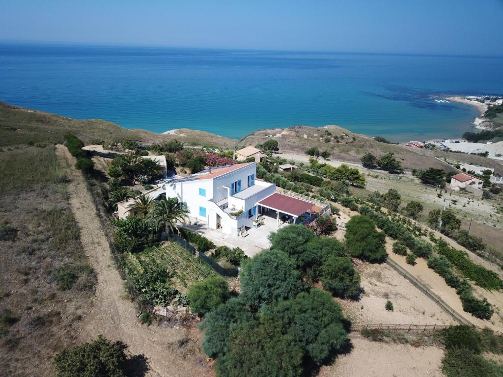 an aerial view of a house on a hill next to the ocean at B&B Monterosso in Realmonte