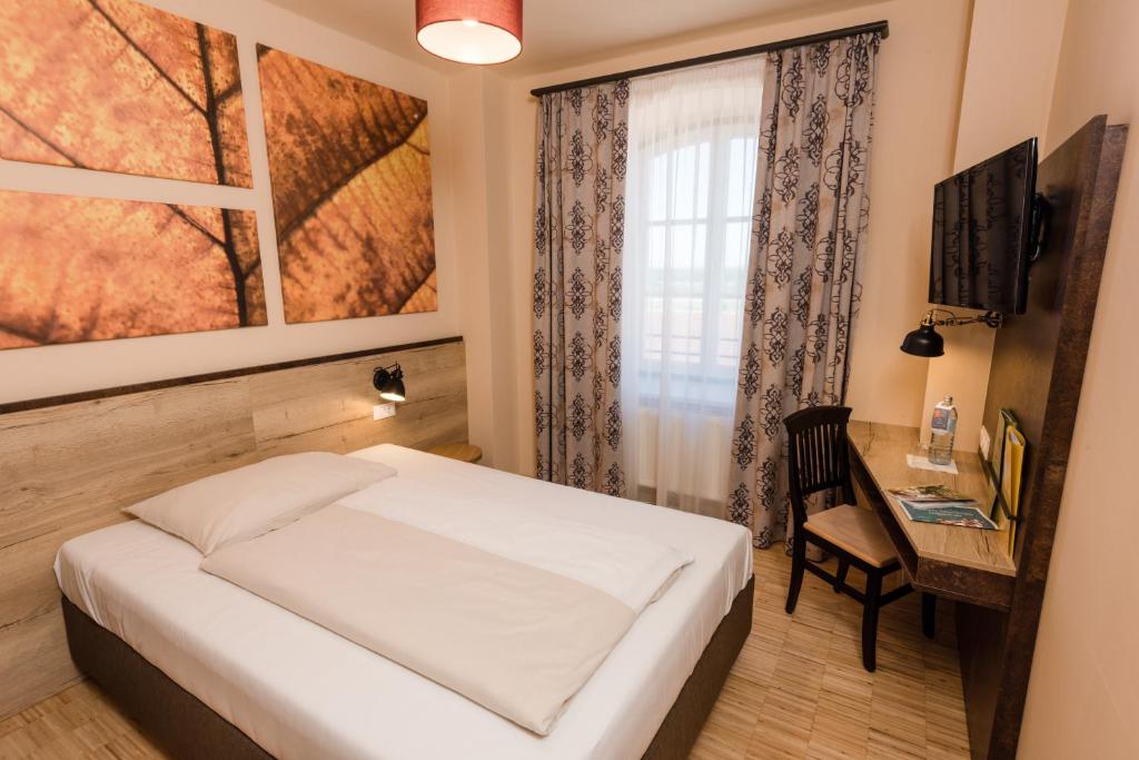 Postel nebo postele na pokoji v ubytování JUFA Hotel Fürstenfeld