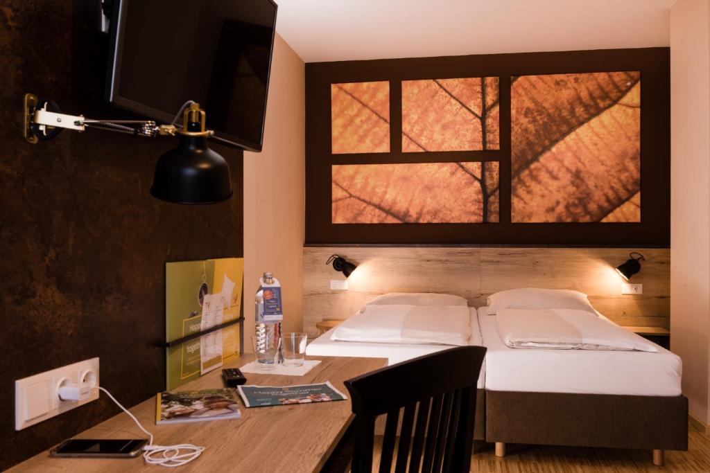 Postel nebo postele na pokoji v ubytování JUFA Hotel Fürstenfeld