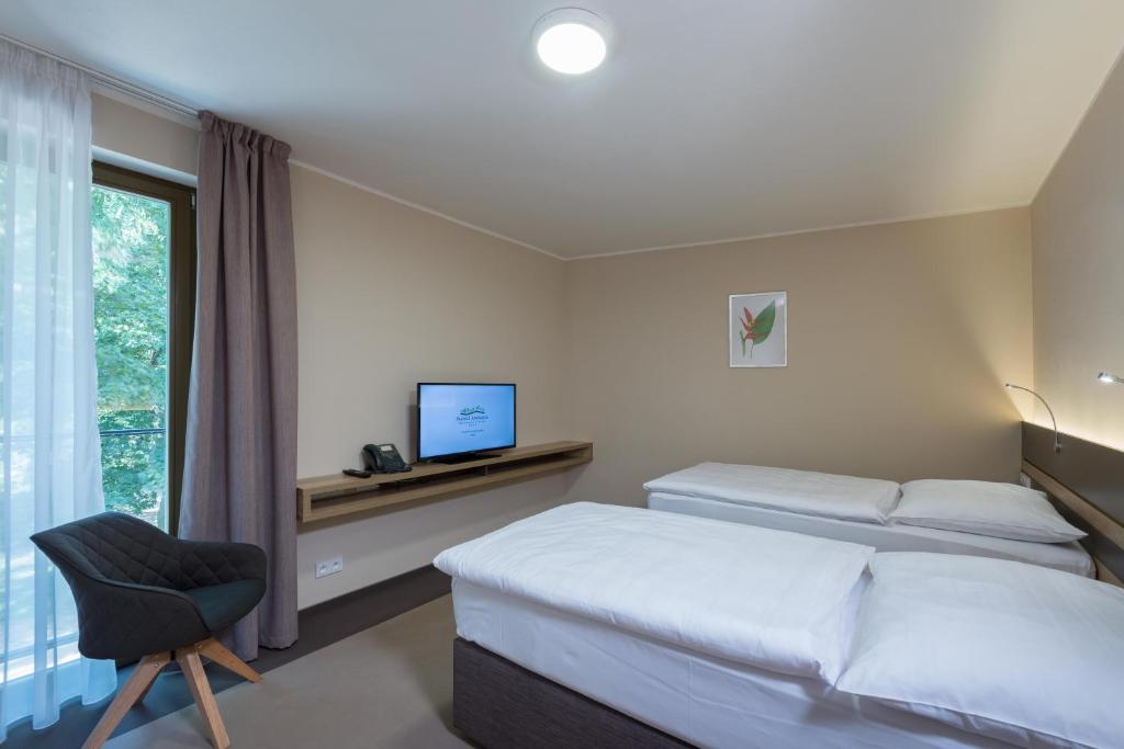 Postel nebo postele na pokoji v ubytování Hotel Panská Zahrada