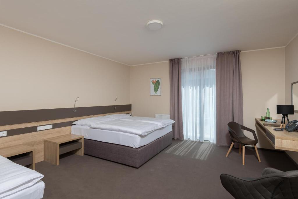 Postel nebo postele na pokoji v ubytování Hotel Panská Zahrada