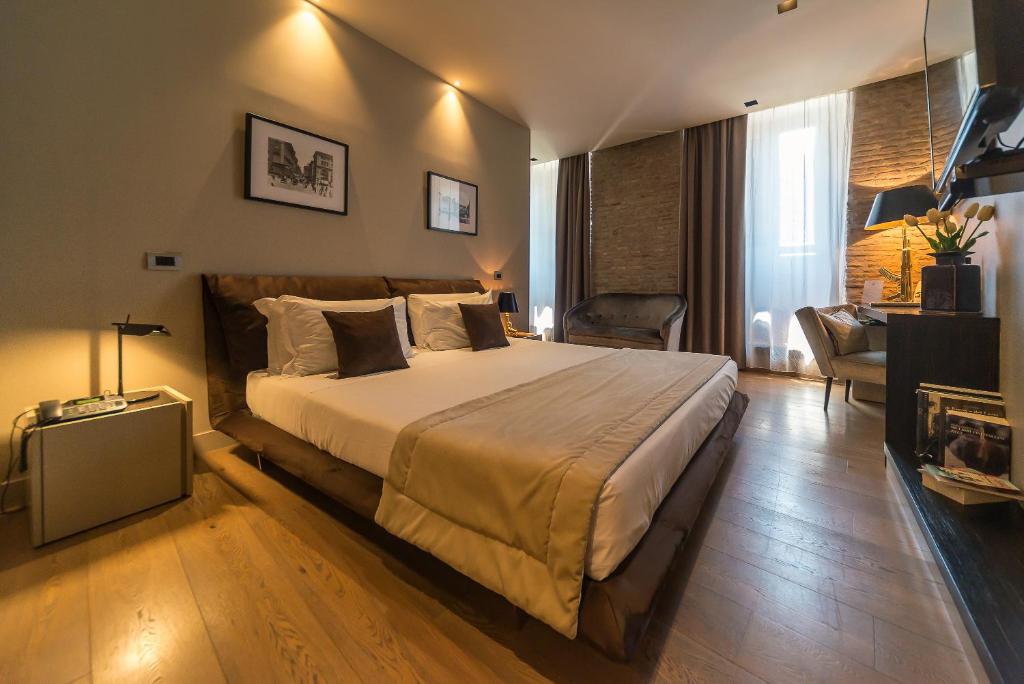 a bedroom with a large bed and a living room at Campo Marzio Luxury Suites in Rome