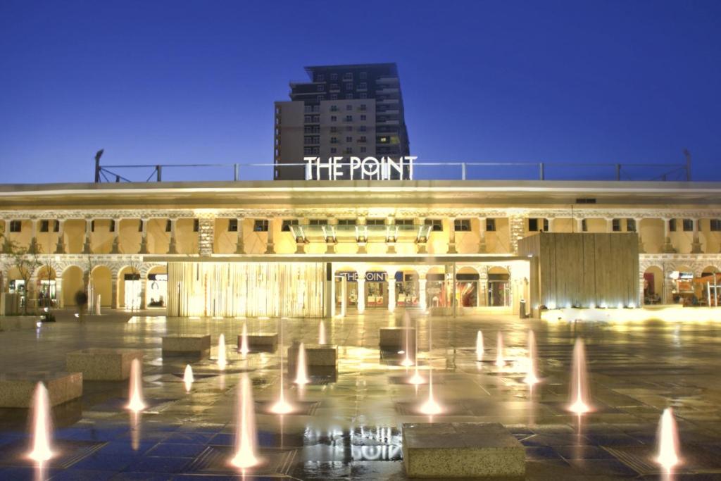 a building with a fountain in front of it at Modern 2BR Sliema Apartment in Sliema