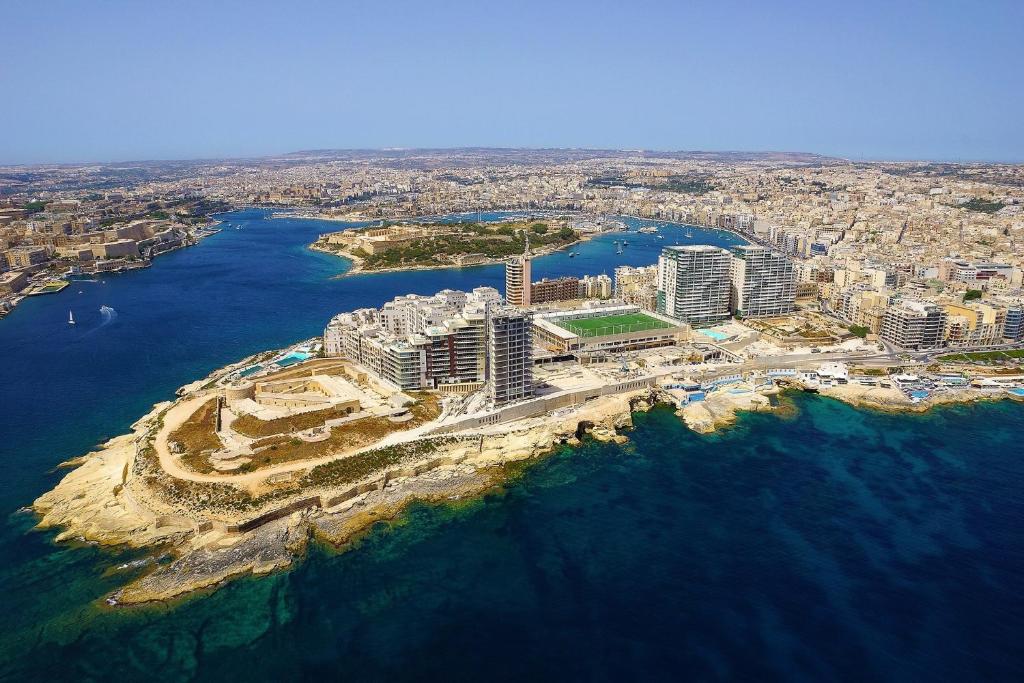 an aerial view of a city next to the ocean at Modern 2BR Sliema Apartment in Sliema