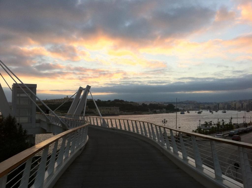 a bridge over a river with a cloudy sky at Modern 2BR Sliema Apartment in Sliema