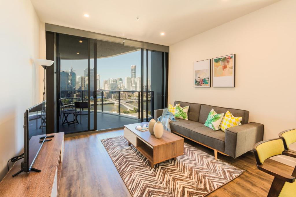 a living room with a couch and a table at AirTrip Apartments at South Brisbane in Brisbane