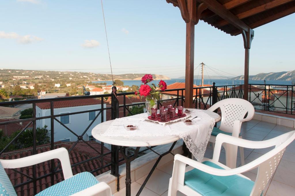 a table and chairs on a balcony with a view at The house of "Angelina", magnificent view of the sea in Methoni