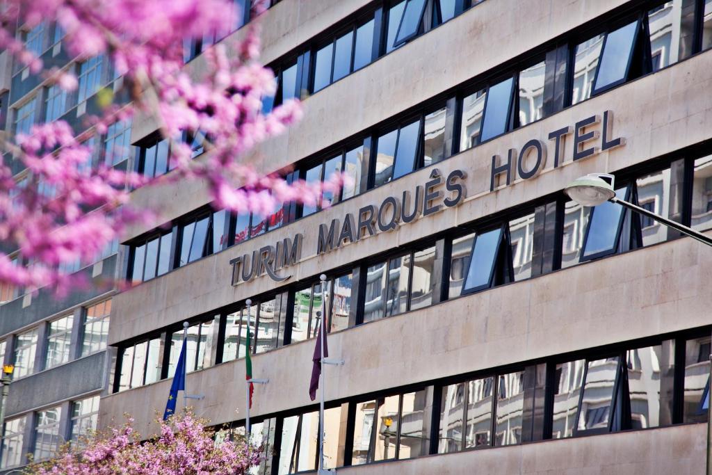 a building with the sign of the new marriott marquise hotel at TURIM Marquês Hotel in Lisbon
