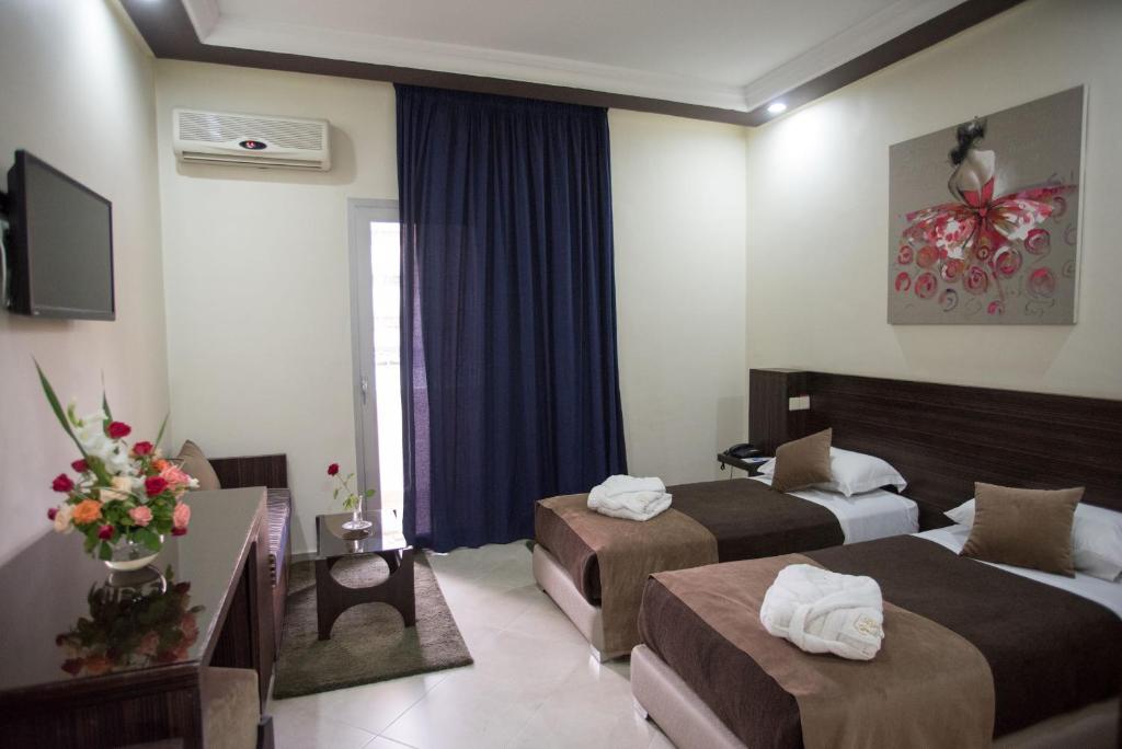 Postel nebo postele na pokoji v ubytování Hôtel Rif