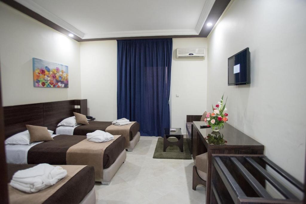 Postel nebo postele na pokoji v ubytování Hôtel Rif