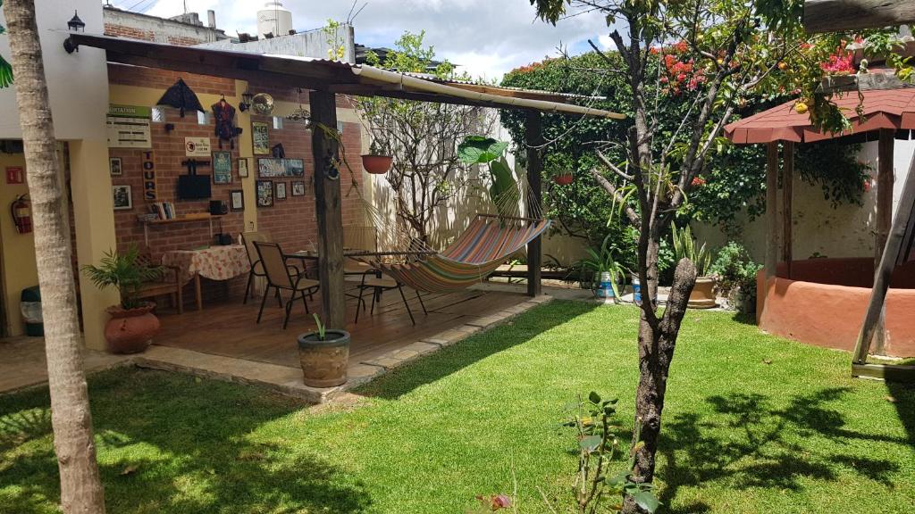 a patio with a hammock in a garden at Yagil B&B in San Cristóbal de Las Casas