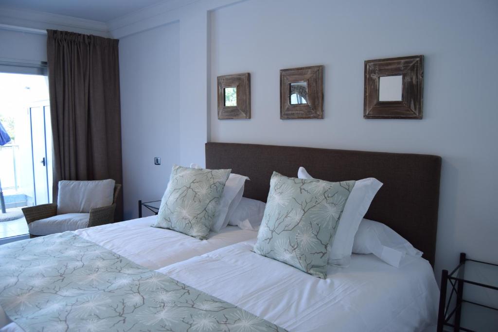 プエルト・デ・モガンにあるDeisy apartments 1Gのベッドルーム1室(白いシーツと枕のベッド1台付)