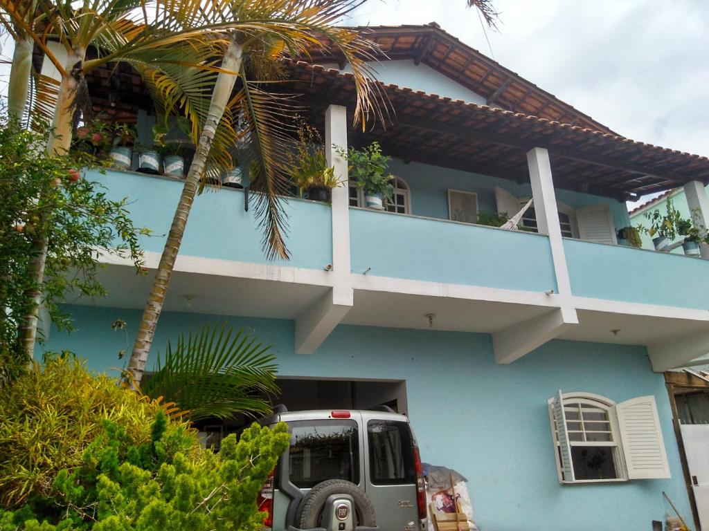 un camión estacionado frente a una casa azul en Hostel Cantinho da Paz en Caxambu