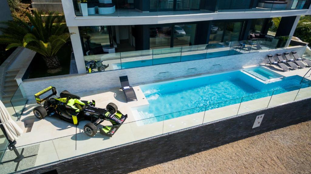 a toy car parked next to a swimming pool at Villa Valis in Baška