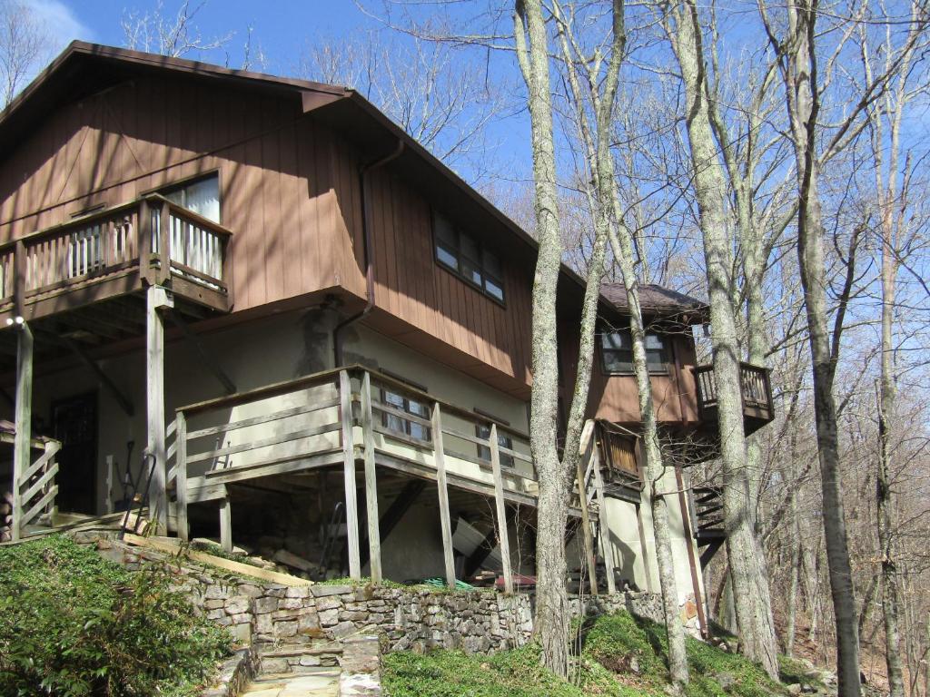 a large wooden house on a hill with trees at Sugar Mountain Drive 1866 Home in Sugar Mountain