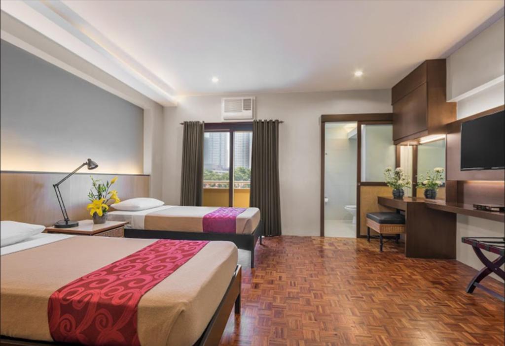 Postel nebo postele na pokoji v ubytování Tropicana Suites