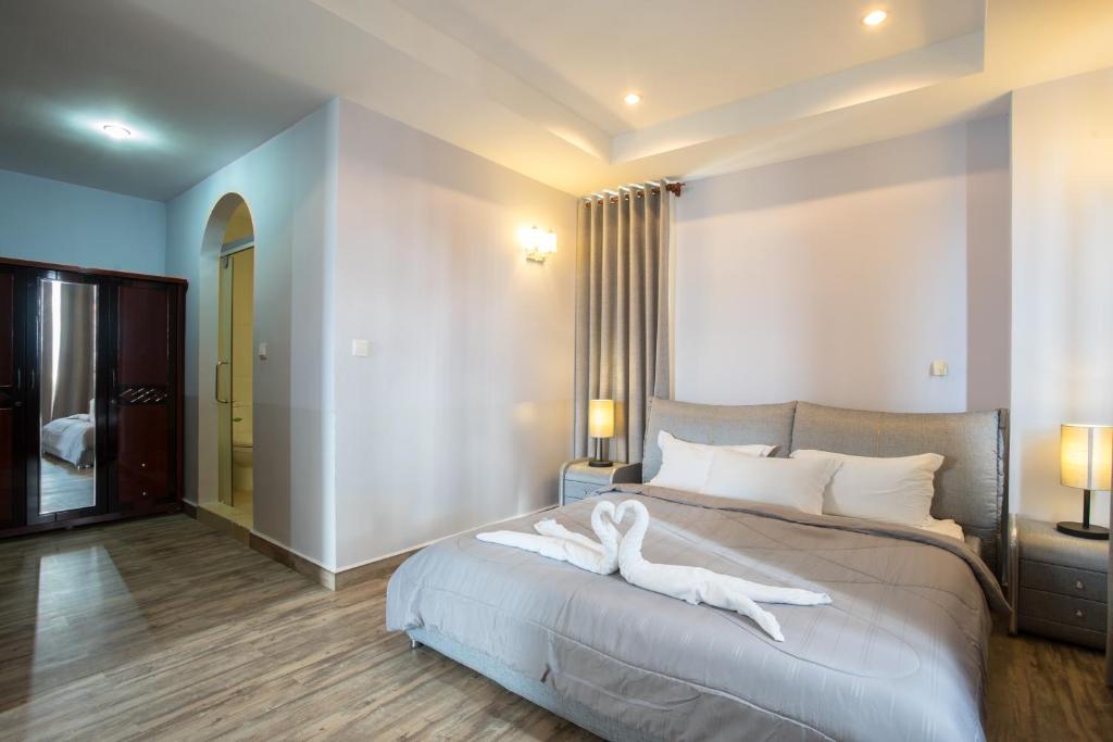 Postel nebo postele na pokoji v ubytování MekongView 1 CondoTel