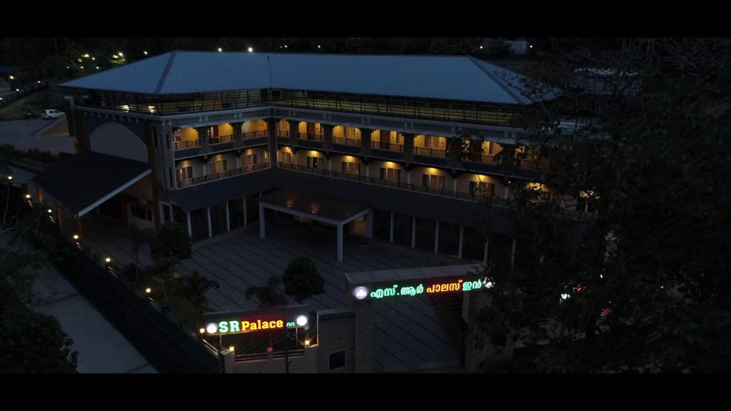 an overhead view of a large building at night at Sr Palaceinn in Kolattupuzha