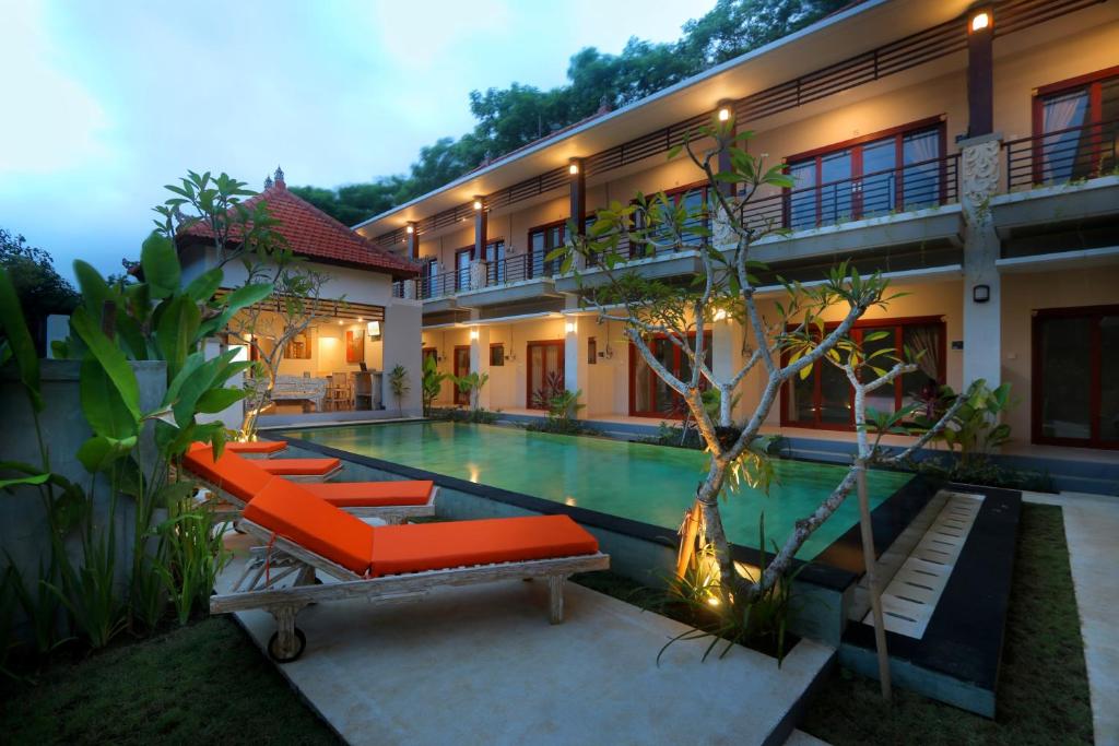 a villa with a swimming pool and a resort at Avisara Villa & Suite in Nusa Dua