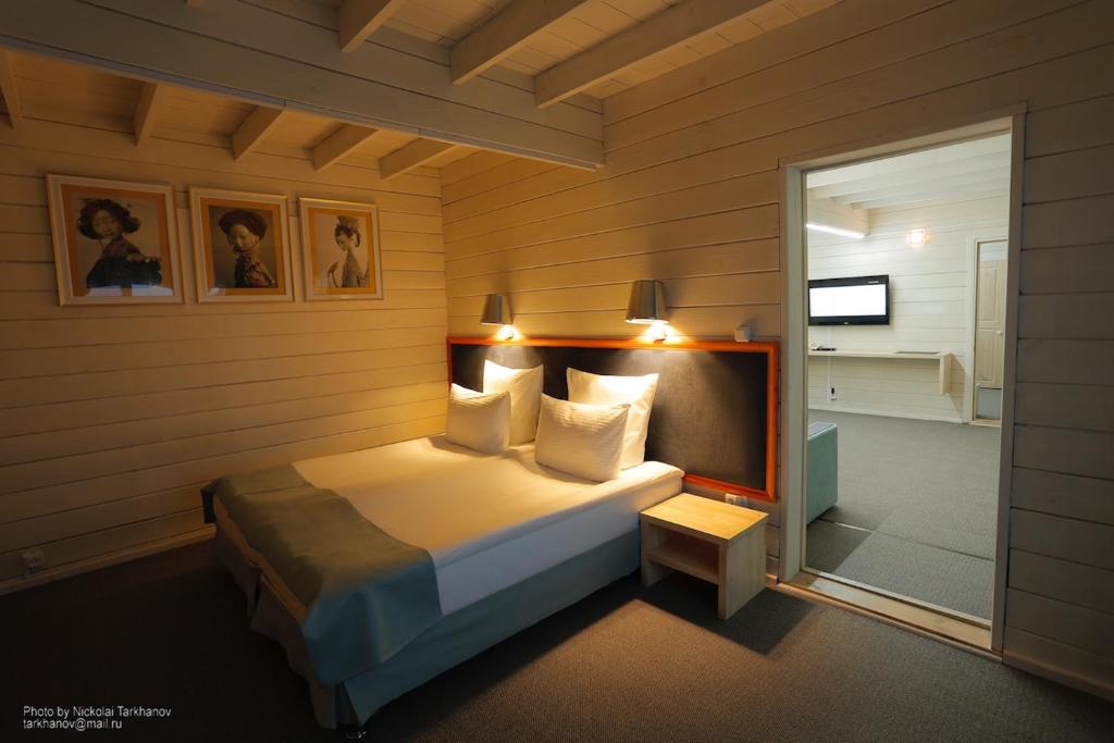 a bedroom with a bed and a window at Baikal View Hotel in Khuzhir