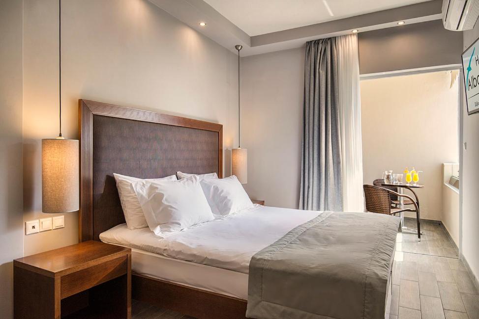 A bed or beds in a room at Albatros Hotel