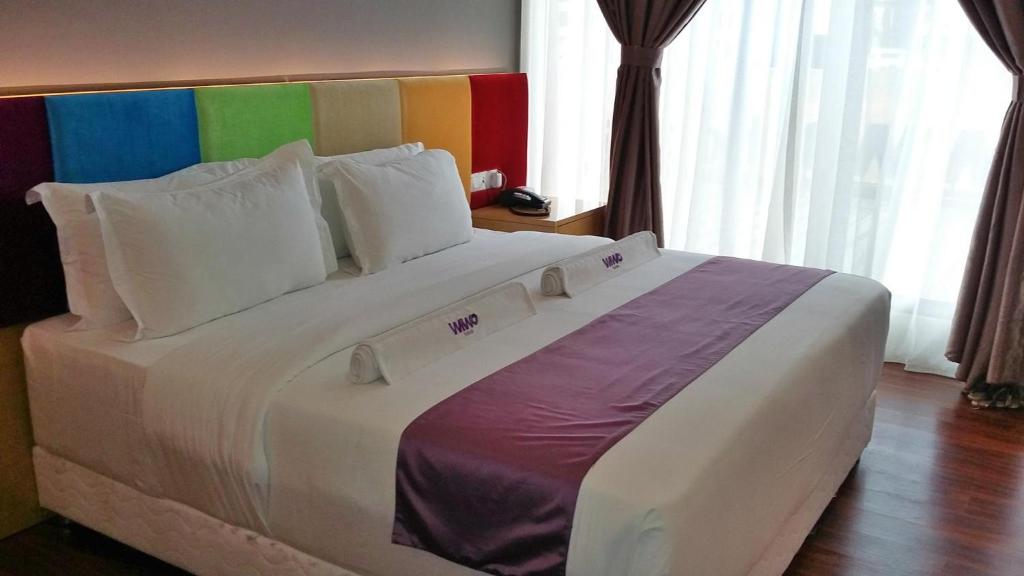 Postel nebo postele na pokoji v ubytování WIWO Hotel
