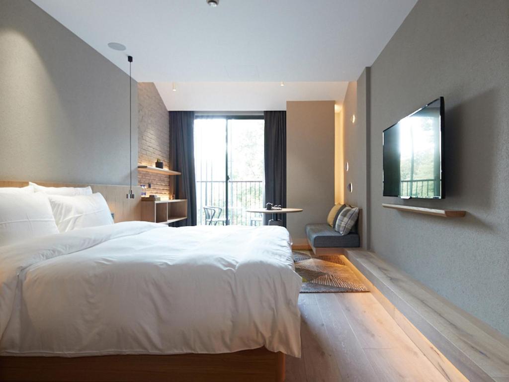 Voodi või voodid majutusasutuse EBO Hotel Hangzhou Wulin - 5 mins drive to the West Lake toas