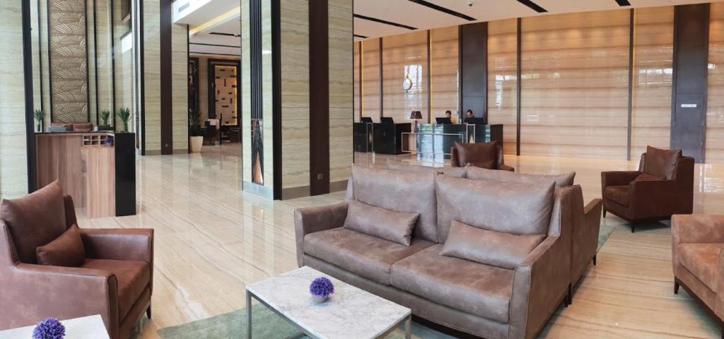 a lobby with couches and tables in a building at KSL Hot Spring Resort in Johor Bahru