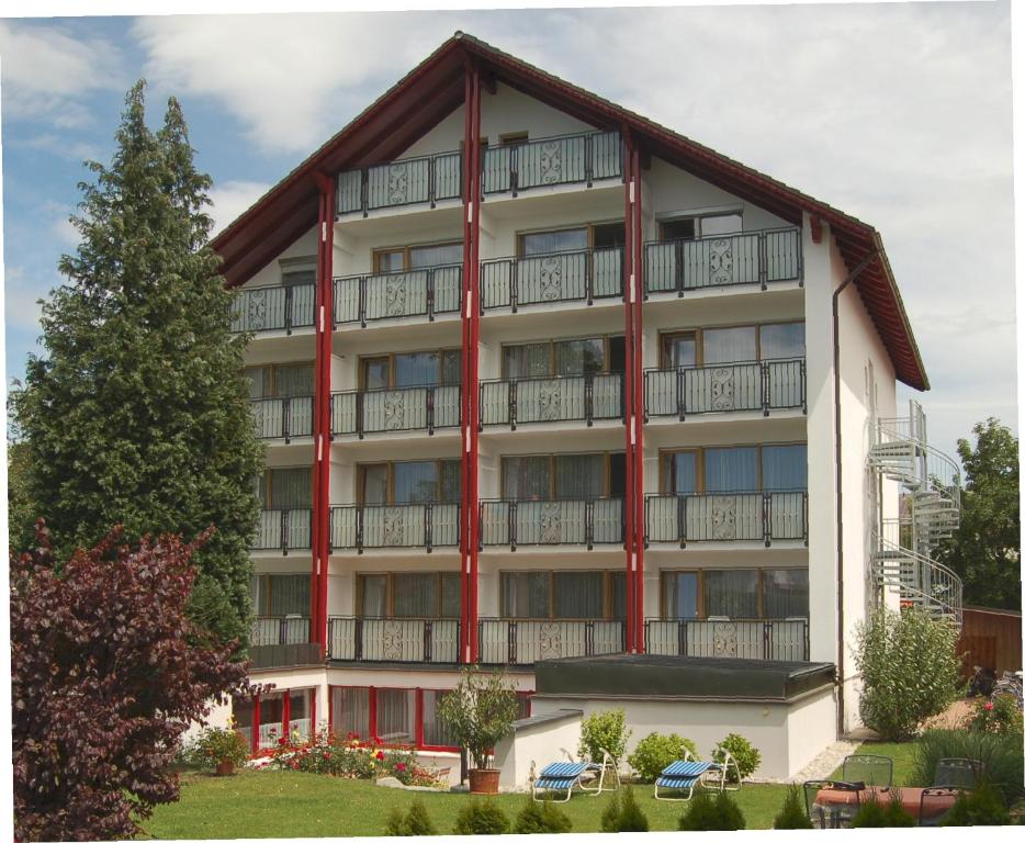 an apartment building with red trim at Pension Maximilian in Bad Füssing