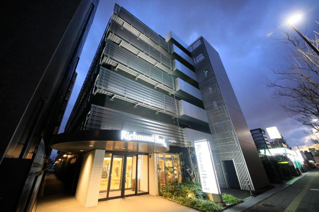 a building with a sign on the front of it at Richmond Hotel Higashi Osaka in Osaka