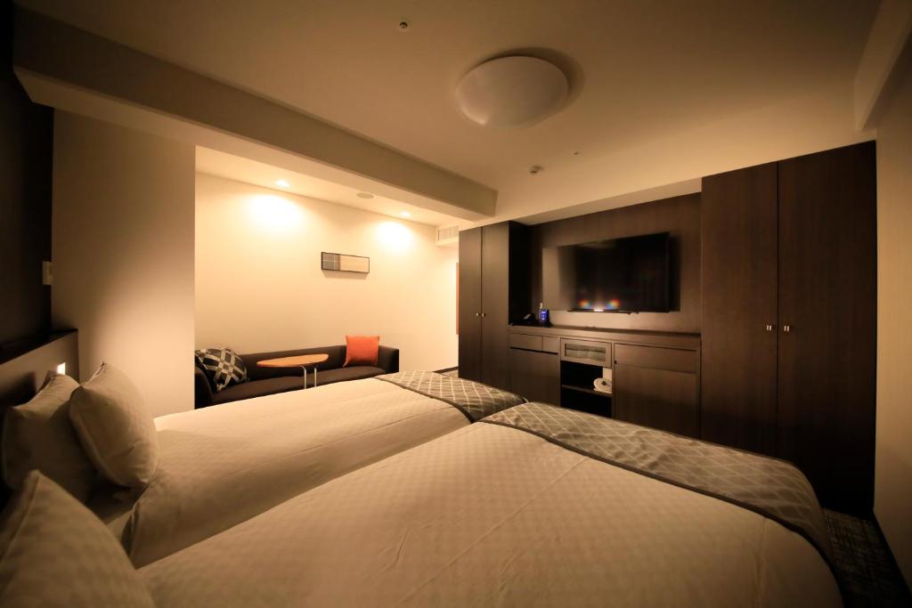 Postel nebo postele na pokoji v ubytování Richmond Hotel Higashi Osaka