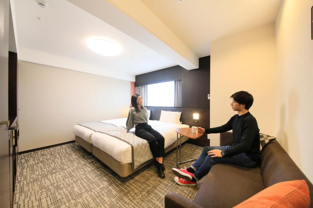 Postel nebo postele na pokoji v ubytování Richmond Hotel Higashi Osaka