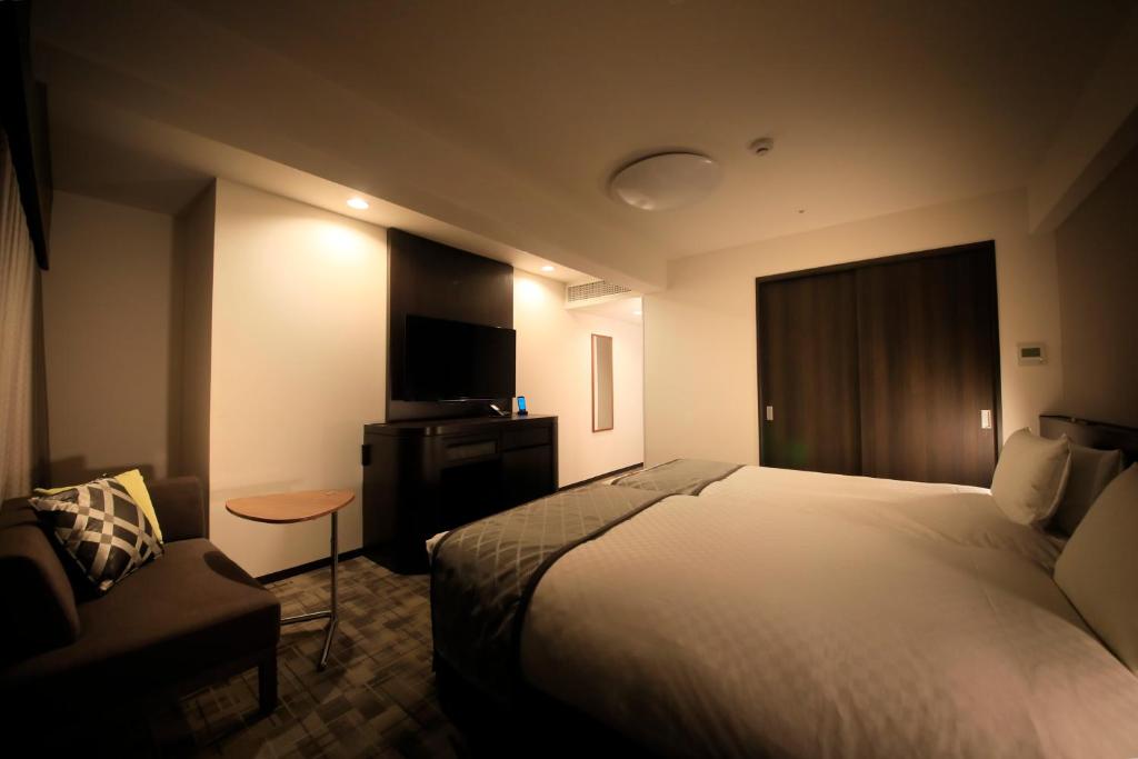 Postel nebo postele na pokoji v ubytování Richmond Hotel Higashi Osaka