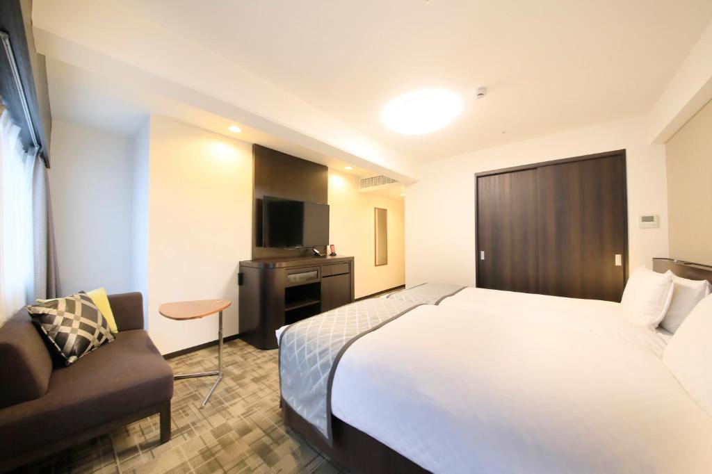 Postel nebo postele na pokoji v ubytování Richmond Hotel Higashi Osaka