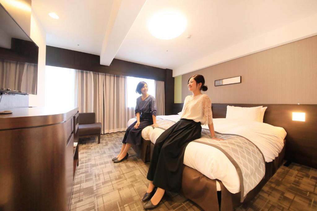 Postel nebo postele na pokoji v ubytování Richmond Hotel Higashi Osaka