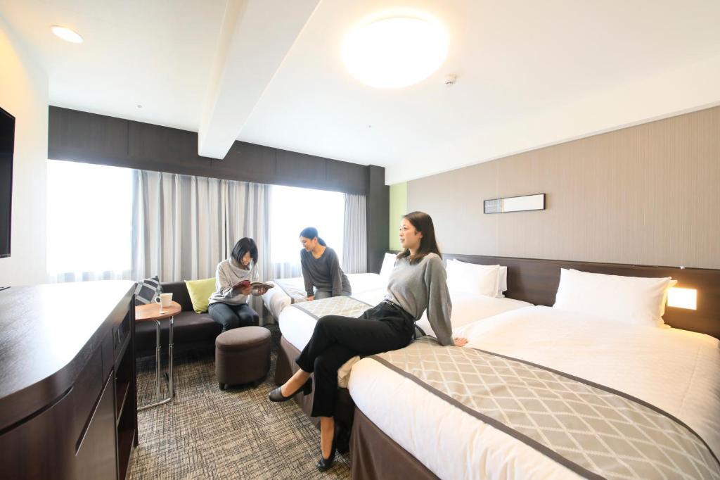 Postel nebo postele na pokoji v ubytování Richmond Hotel Higashi Osaka