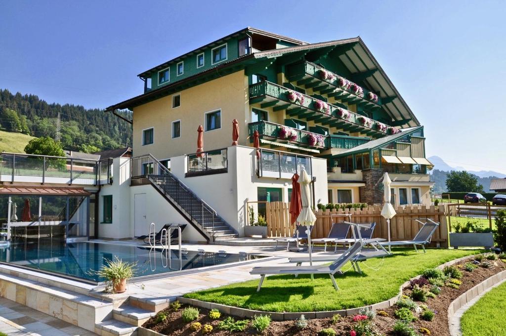 a building with a pool in front of it at Hotel Druschhof in Schladming