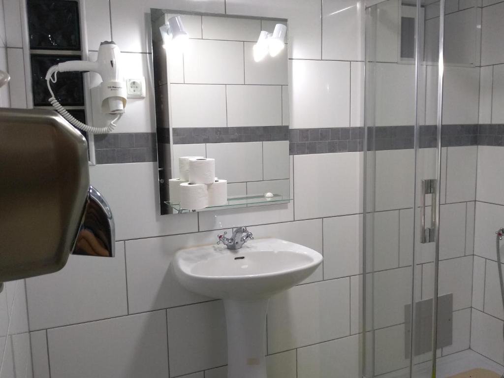 a bathroom with a sink and a mirror at Hostel Nature in Zambujeira do Mar