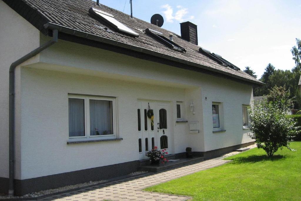 uma casa branca com uma janela e um telhado em Ferienwohnung in der Vulkaneifel em Ulmen