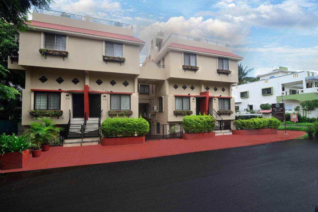 a building with a red driveway in front of it at ShreeVilla Corporate Guest House in Nashik
