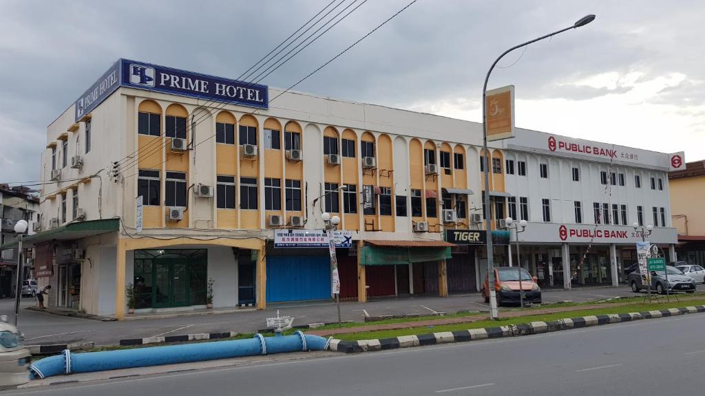 a building on the corner of a street at Prime Hotel in Limbang