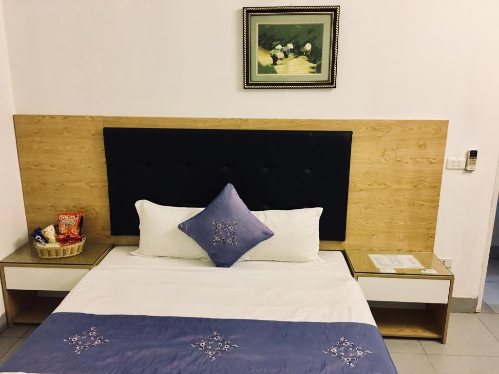 Postel nebo postele na pokoji v ubytování Hotel Hoang Gia