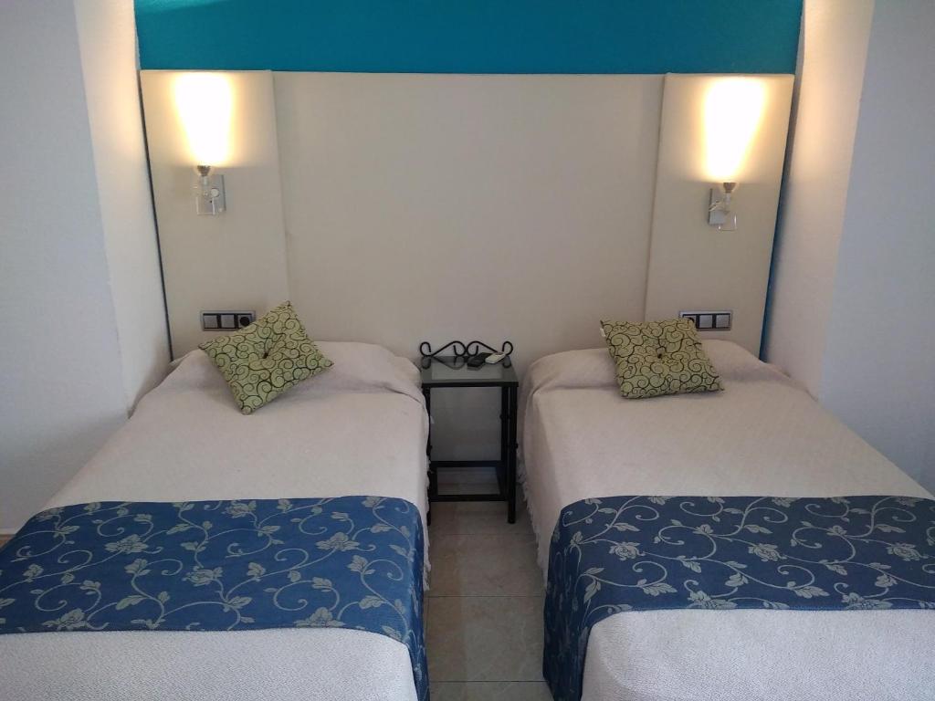 Posteľ alebo postele v izbe v ubytovaní Hotel Nuevo Ara