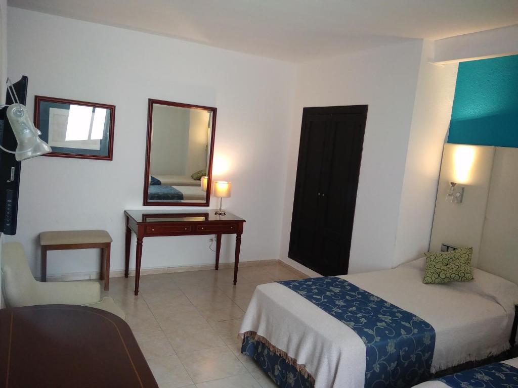Posteľ alebo postele v izbe v ubytovaní Hotel Nuevo Ara
